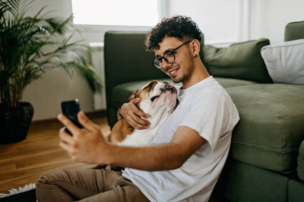 istock Young man playing with his dog 1325357518