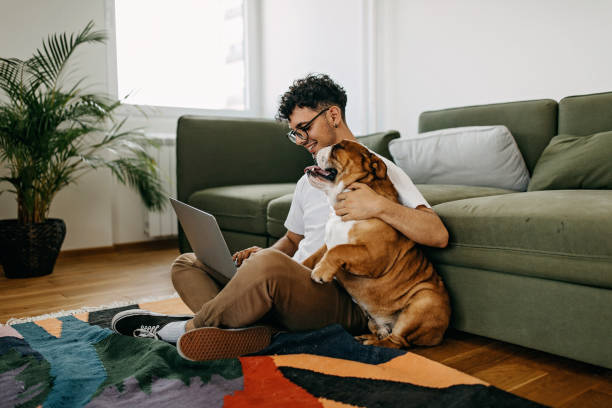 istock Young man working and playing with his dog 1325357569