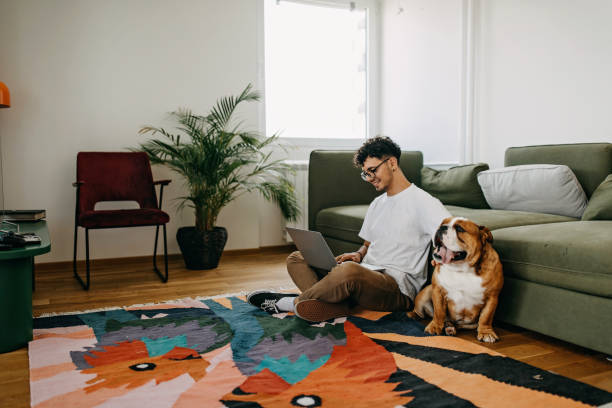 istock Young man working and playing with his dog 1325357574