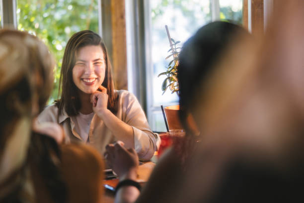 istock Girls Gossiping at a Cafe 1325357592