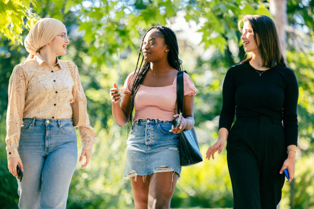 istock Friends walking together in a park 1325357721