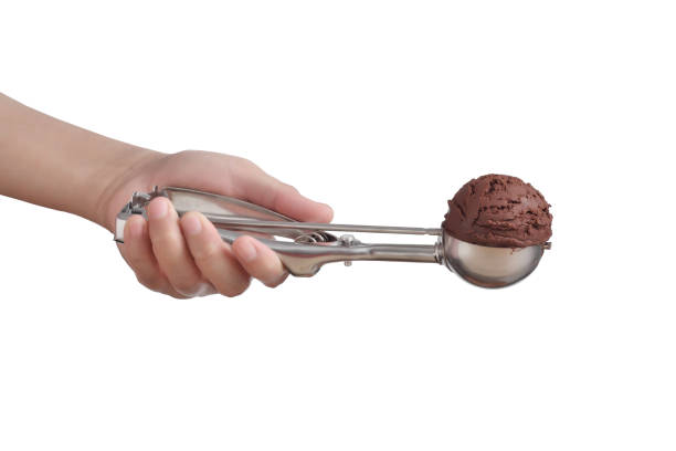 istock Hand holding chocolate ice cream in spoon for scoop isolated on white background 1325357896