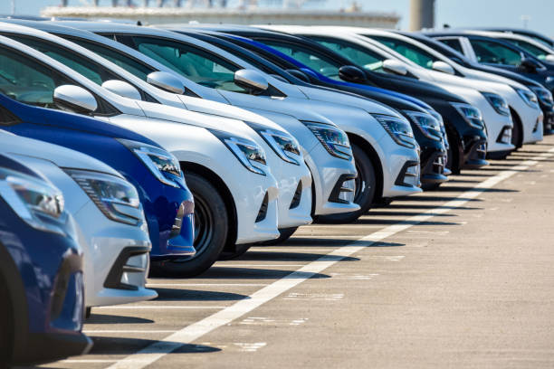 Brand new Renault cars lined up in a parking lot. Le Havre, France - June 16, 2021: Brand new Renault cars are lined up in the parking lot of the roll-on/roll-off (ro-ro) terminal of Le Havre port. automobile industry stock pictures, royalty-free photos & images
