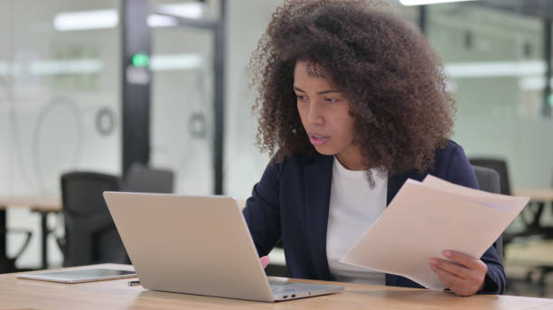 istock African Businesswoman with Laptop having Failure on Documents 1325363445