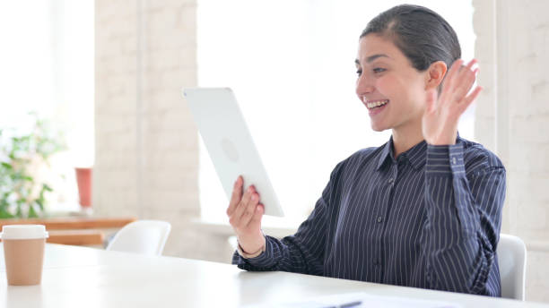 istock Indian Woman doing Online Video Chat on Tablet 1325363466