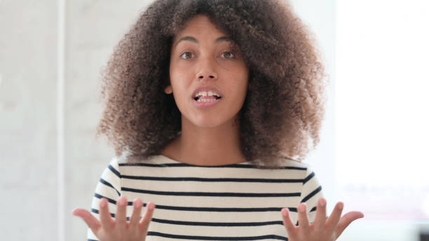istock Aggressive African Woman Angry on Online Video Chat 1325363498