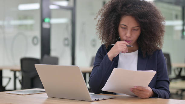 istock African Businesswoman Working on Laptop and Documents 1325363535