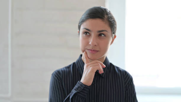 istock Pensive Young Indian Woman Thinking New Plan 1325363573