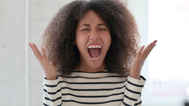 istock Angry African Woman Shouting and Screaming 1325363660