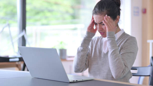 istock Stressed Young Indian Woman with Laptop having Headache at Work 1325364508
