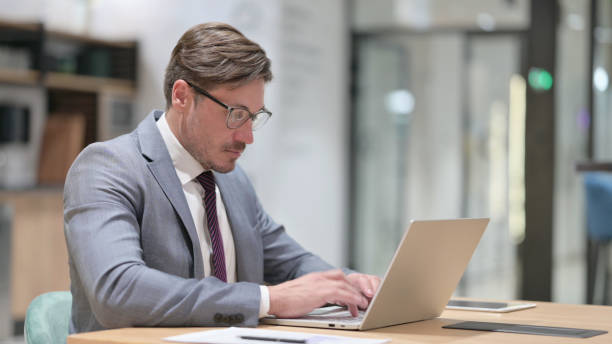istock Professional Businessman Working on Laptop in Office 1325364603