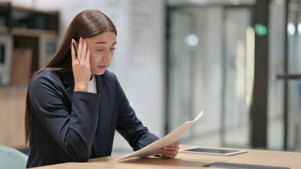 Disappointed Businesswoman with Documents Reacting to Failure