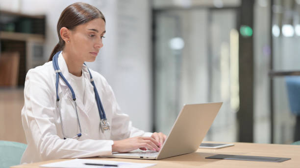 istock Female Doctor Working on Laptop in Office 1325365388