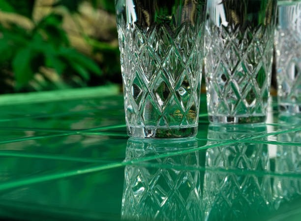 istock Refreshing summer drinks in crystal glasses on yellow bar tile background with harsh shadows Sweet cold natural cocktail 1325367746