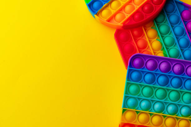 istock Colorful antistress pop it toy on yellow background 1325367946