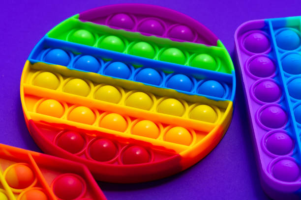 istock Colorful antistress pop it toy on purple background 1325368670