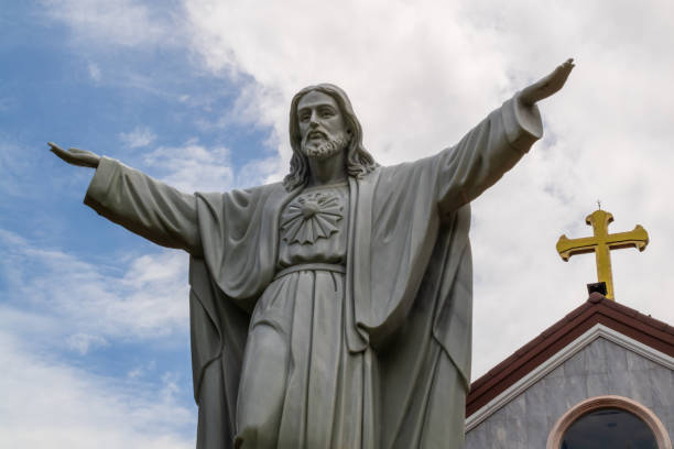istock Statue of jesus with open arms 1325368716