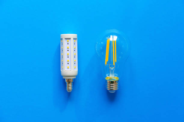istock Light bulbs on blue paper background close up 1325369635