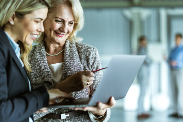 istock Happy businesswomen cooperating while using laptop in the office. 1325370481
