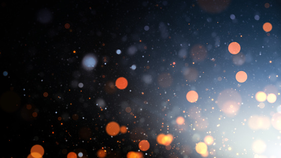 Defocused Lights and Particles Over Dark Background
