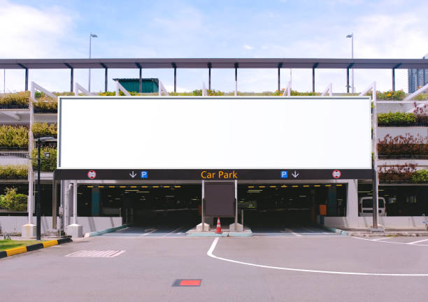 blank advertising large billboard banner mockup, outside multi-storey carpark with eco green wall, above entrance. large digital display screen, an out-of-home ooh media display space. - entrance sign imagens e fotografias de stock