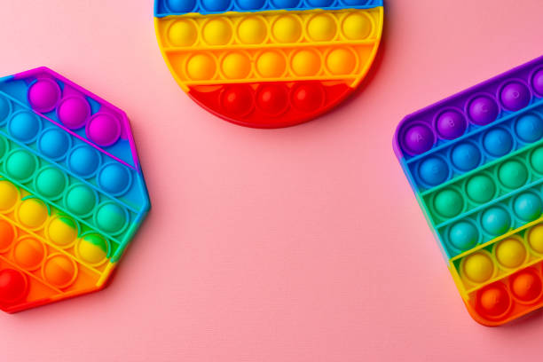 istock Colorful antistress pop it toy on pink background 1325376572