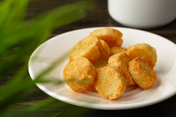 Baked small cheese cookies heap close up photo