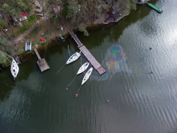 Photo of Aerial view of a water pollution. Oil stain on the water from the yacht. Environmental disaster.