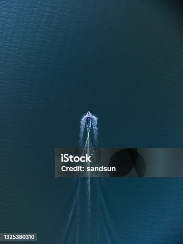 istock Top view of a boat sailing in the lake 1325380310
