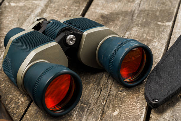 istock Hunting equipment binoculars on wooden background close up 1325380382