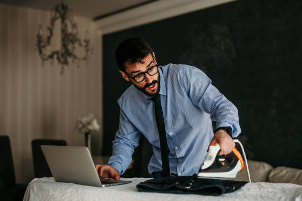istock Businessman multitasking home chores and preparing for work 1325381153