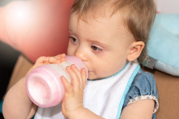istock Baby girl drinking milk from bottle 1325381769