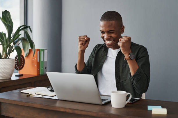 istock Shot of a young businessman celebrating while working from home 1325382484