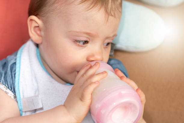 istock Baby girl drinking milk from bottle 1325382778