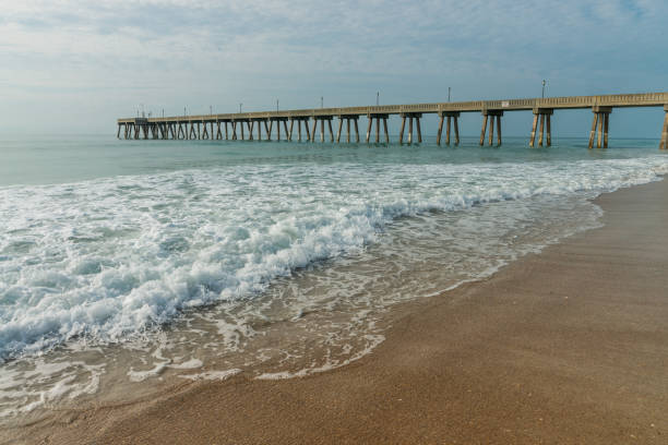 istock Sandy beach and a pier on Atlantic ocean in the morning 1325382786
