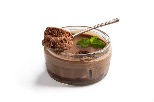 istock Mini caramel cheesecake in a glass pot with spoon isolated on white 1325382830