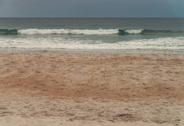 Small waves on sandy beach on Atlantic ocean coast in a sunny summer day