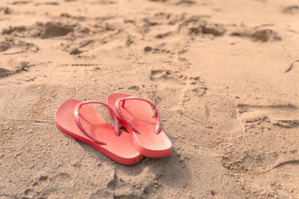 istock A pair of flip-flops on a sandy beach on Atlantic ocean 1325383201