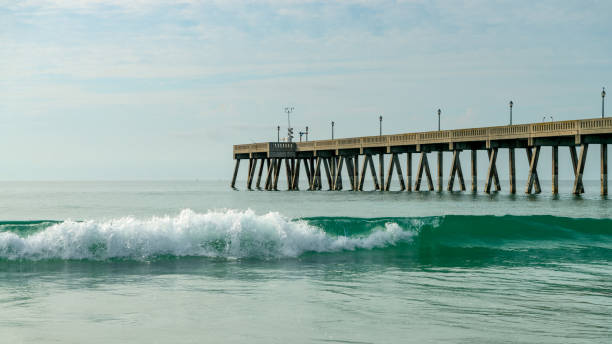 istock Sandy beach and a pier on Atlantic ocean in the morning 1325384064