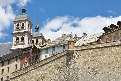 The Vauban city, its ramparts with watchtower, its colorful terraced houses and the bell towers of the church