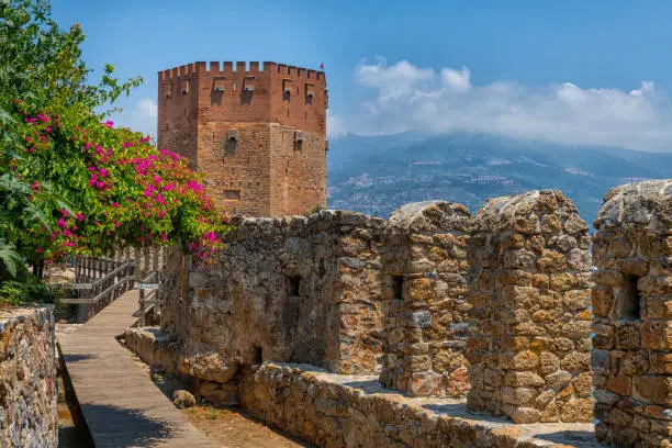 Photo of Red Tower and the fortification wall of a fortress in the Turkish city of Antalya