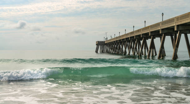 istock Sandy beach and a pier on Atlantic ocean in the morning 1325385566