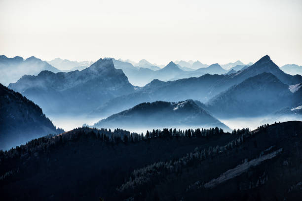 Swiss alps seen from Mount Kronberg in the Appenzell Alps Beautiful high angle panoramic view from mountain peaks in the European alps in Switzerland. Hazy atmosphere on a beautiful autumn day. swiss culture photos stock pictures, royalty-free photos & images