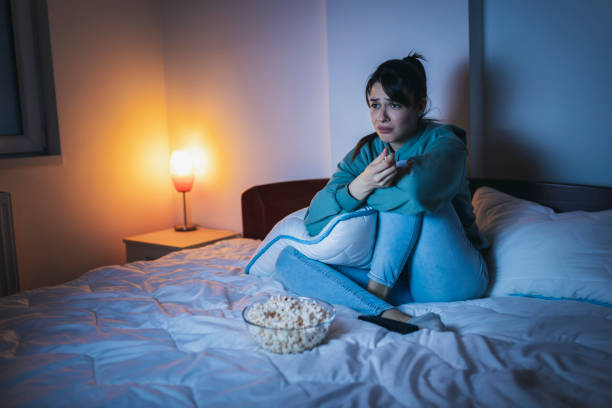 istock Woman crying while watching sad movie on TV 1325385759