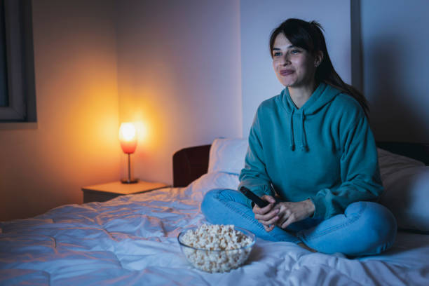 istock Woman having fun watching TV 1325385808