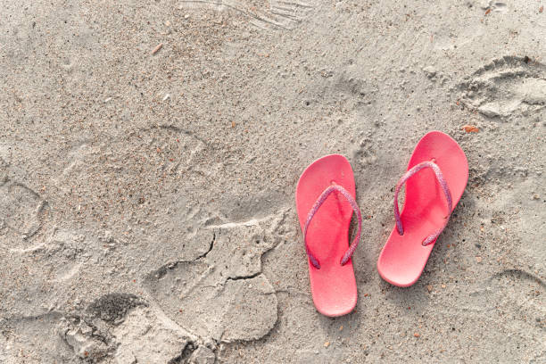 istock A pair of flip-flops on a sandy beach on Atlantic ocean 1325387338