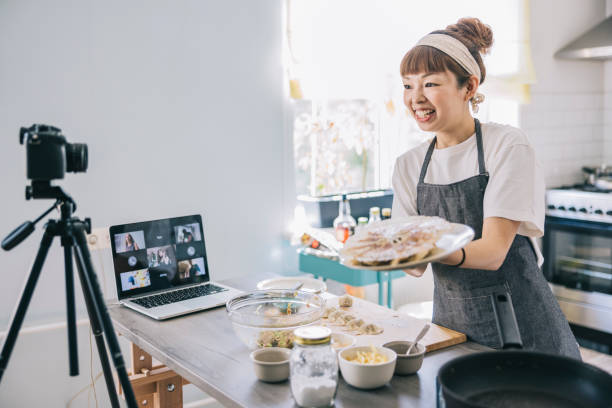 istock Japanese woman making gyozas for her audience 1325387506