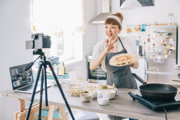 istock Japanese woman filming gyoza tutorial 1325387519