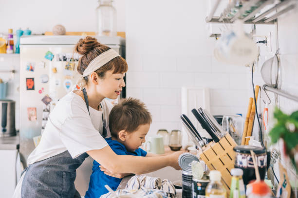 istock Mother and son washing hands in kitchen 1325387525