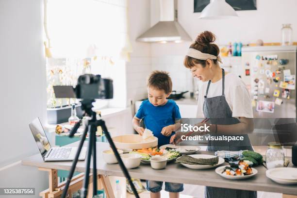 Mother And Son Recording Cooking Tutorial Stock Photo - Download Image Now - Sushi, Child, Cooking